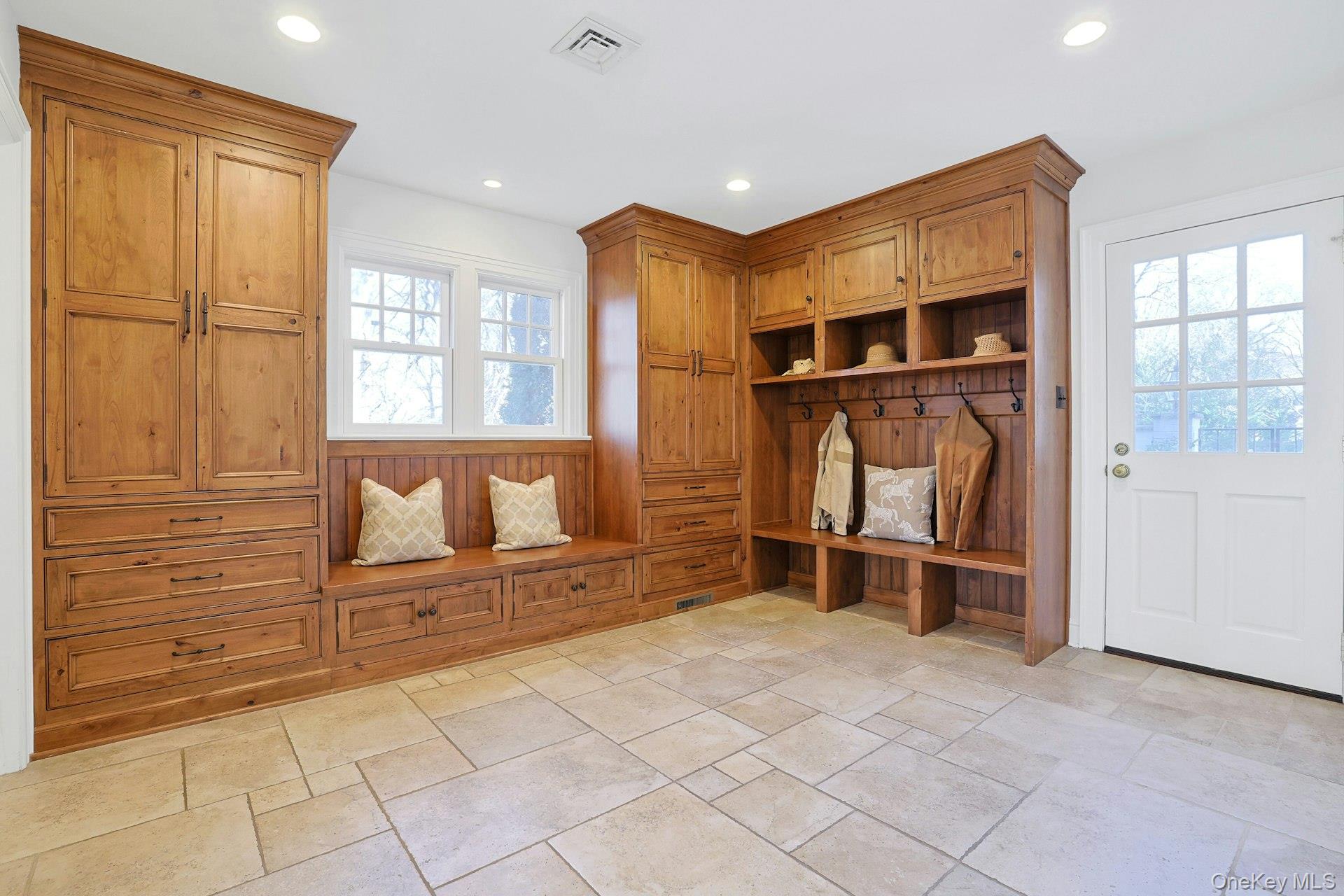 369 Evandale Road Scarsdale, NY 10583 - Photo 20 of 49 Large mud room with two walls of custom built-ins, three over-sized closets, one used as a pantry, a full bath and a laundry room, both with radiant heated floors and a door leading to the patio.