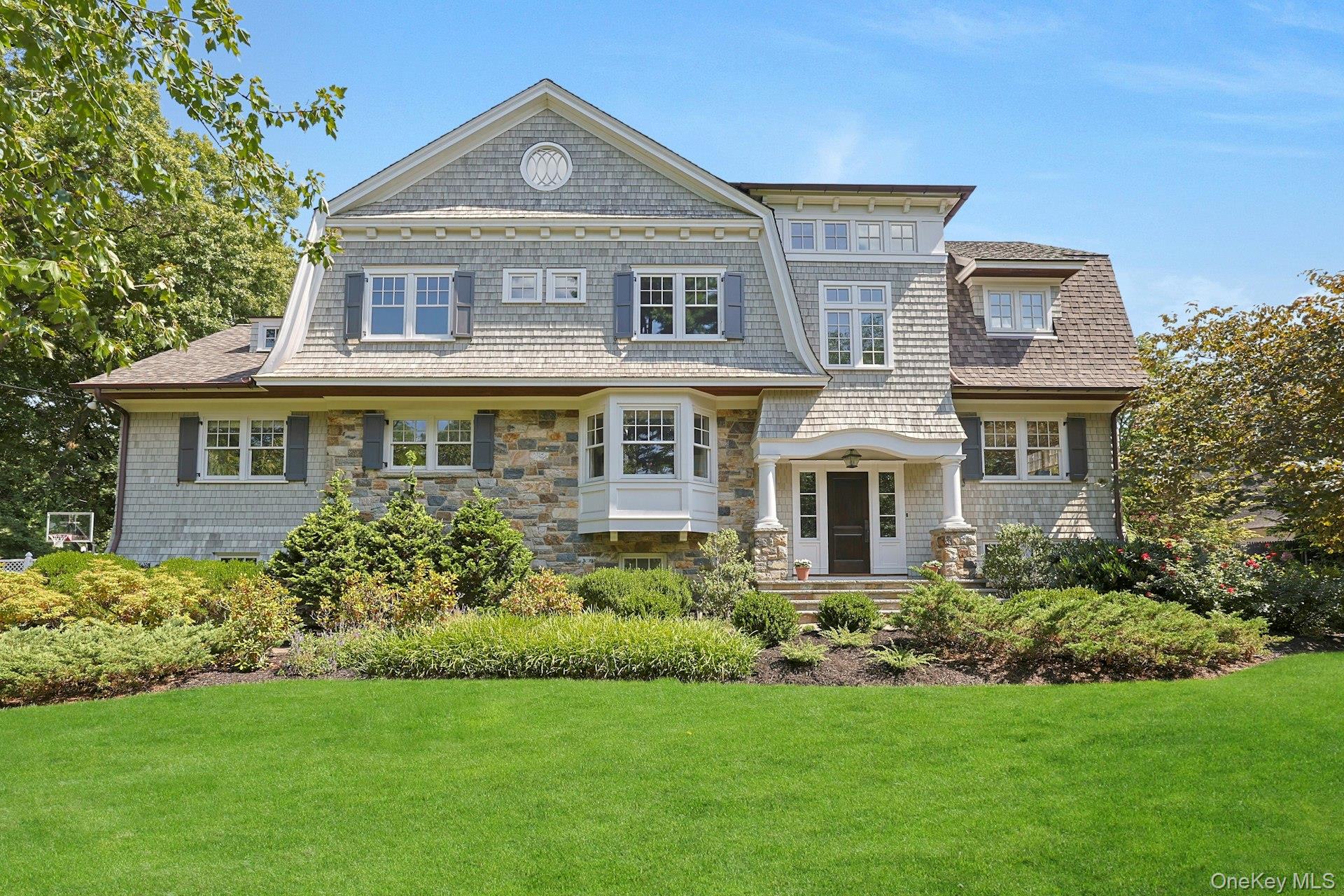 369 Evandale Road Scarsdale, NY 10583 - Photo 2 of 49 Striking front elevation with timeless curb appeal, mature landscaping, and a gracious approach.
