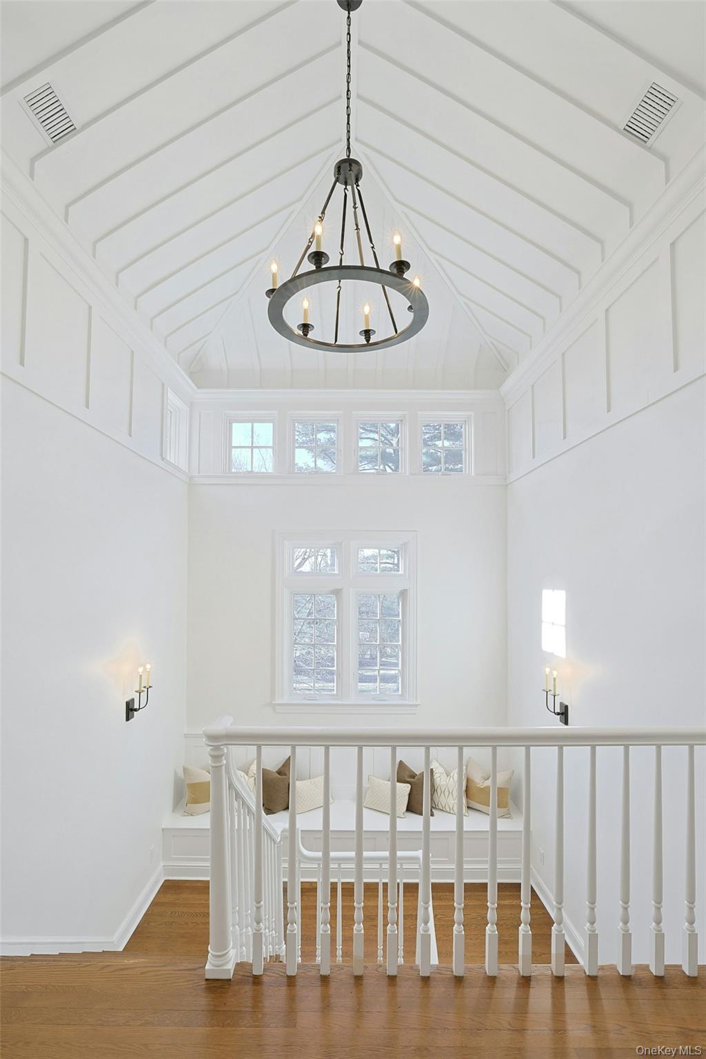 369 Evandale Road Scarsdale, NY 10583 - Photo 22 of 49 Second level landing with charming window-seat, vaulted ceiling, decorative detailing, and a beautiful chandelier.