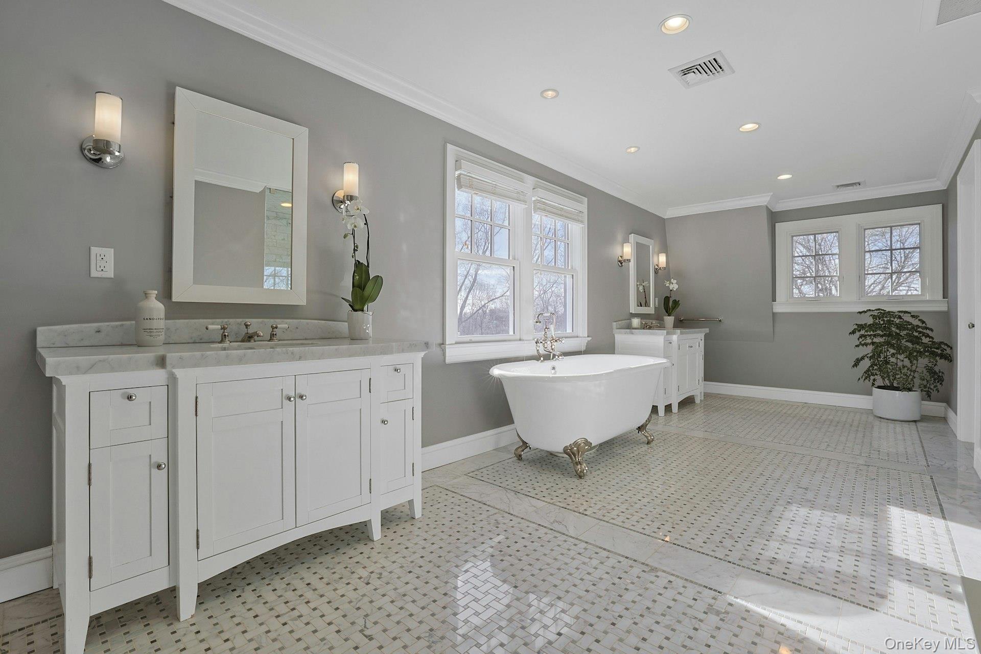 369 Evandale Road Scarsdale, NY 10583 - Photo 25 of 49 Luxurious and airy primary bath with dual vanities, claw foot soaking tub, steam shower, and Carrara marble radiant heated floors.
