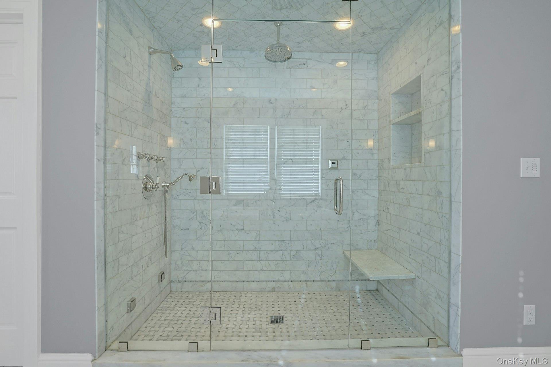 369 Evandale Road Scarsdale, NY 10583 - Photo 26 of 49 Oversized glass enclosed steam shower with built in bench seating, and a sleek rainfall showerhead.