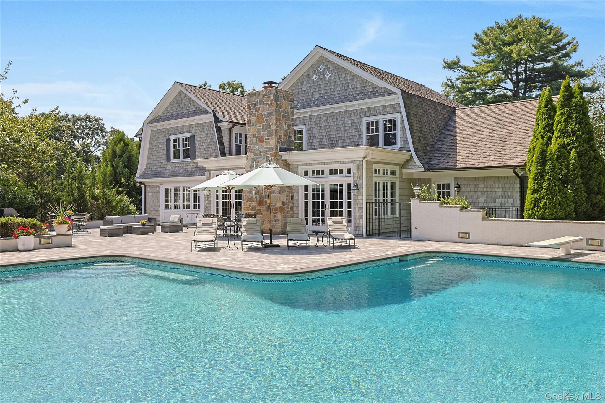 369 Evandale Road Scarsdale, NY 10583 - Photo 37 of 49 Close up view of the L shaped heated saltwater pool and the spectacular patio area, ideal for outdoor lounging and entertaining.