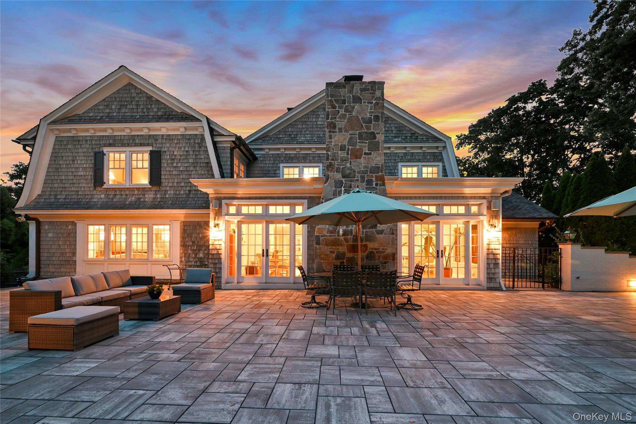 369 Evandale Road Scarsdale, NY 10583 - Photo 40 of 49 Twilight glow highlights the expansive patio, perfect for evening entertaining, dining, and unwinding outdoors.