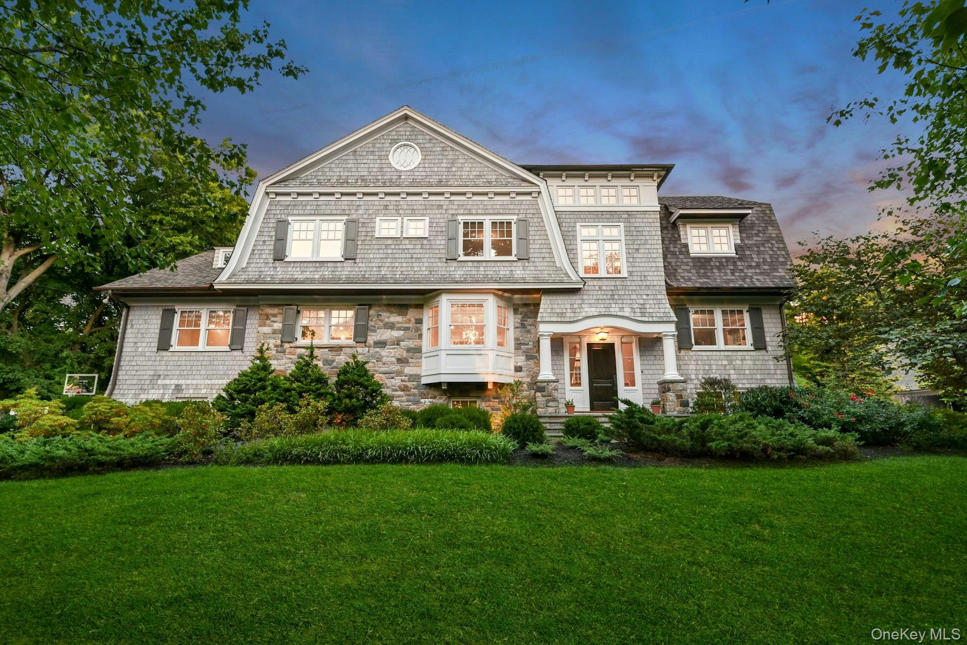 369 Evandale Road Scarsdale, NY 10583 - Photo 45 of 49 Stunning front façade at dusk, highlighting classic architecture and impressive presence from the street.