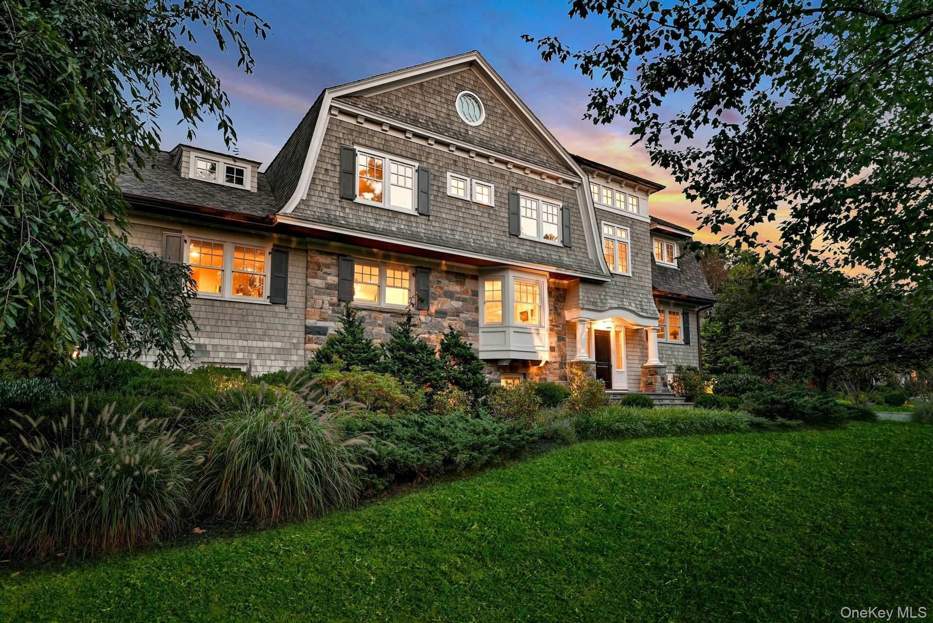 369 Evandale Road Scarsdale, NY 10583 - Photo 46 of 49 Evening exterior showcasing timeless design, mature plantings, and a stunning first impression from every angle.