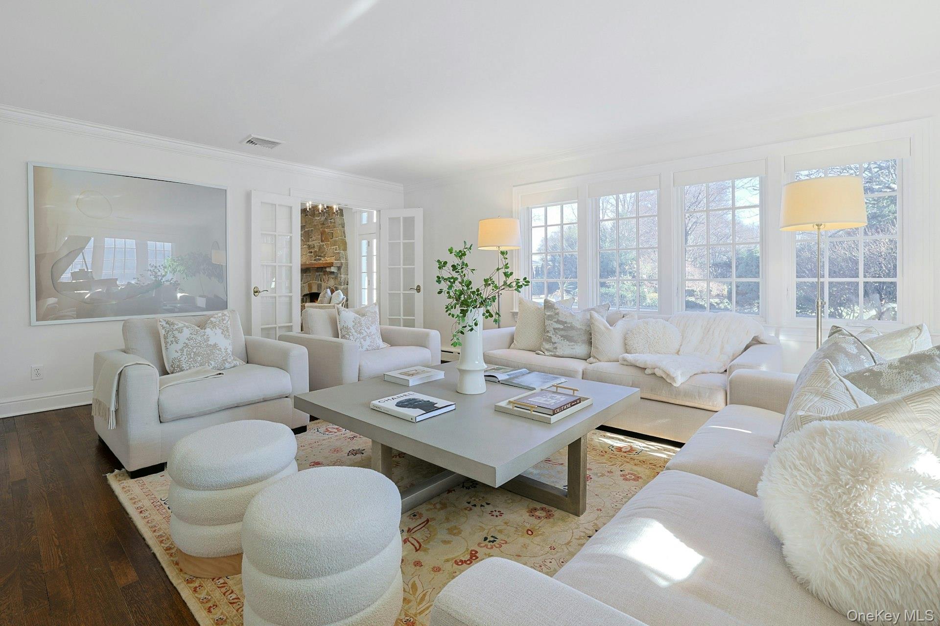 369 Evandale Road Scarsdale, NY 10583 - Photo 6 of 49 Light filled living room featuring a stunning wall of windows with backyard views, plus French doors connecting to the family living space.