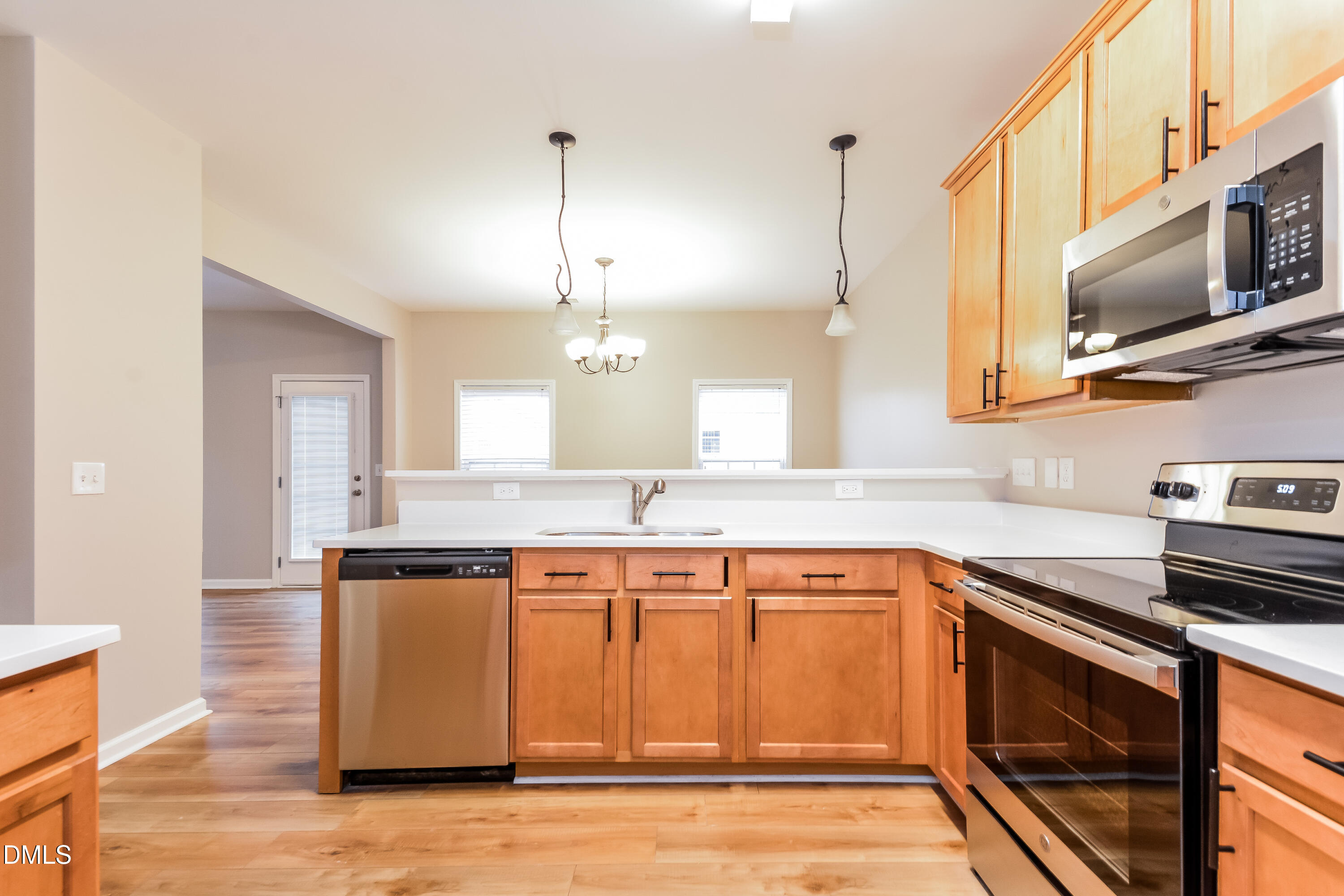 1413 Cozart Street Durham, NC 27704 - Photo 5 of 17 a kitchen with stainless steel appliances granite countertop a sink a stove and a microwave