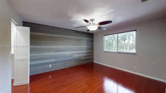a view of room with window and wooden floor