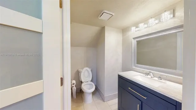 a bathroom with a toilet a sink and mirror