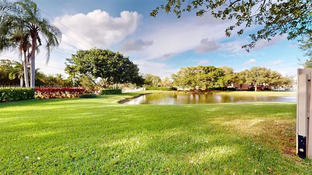 a view of yard with swimming pool and green space