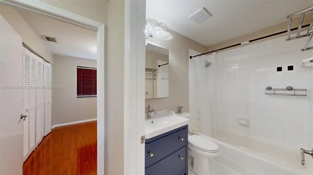a bathroom with a double vanity sink toilet mirror and shower