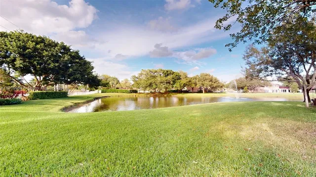 a view of a lake with houses in the background