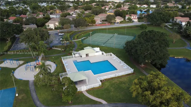 an aerial view of a house with yard swimming pool and outdoor seating