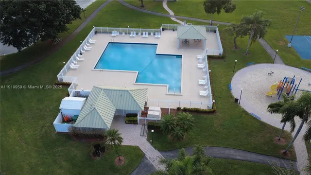 an aerial view of a house with outdoor space and lake view