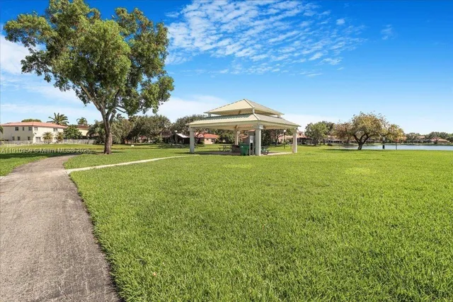 a view of a park with large trees and a big yard