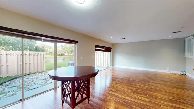 a view of a dining room with furniture window and wooden floor