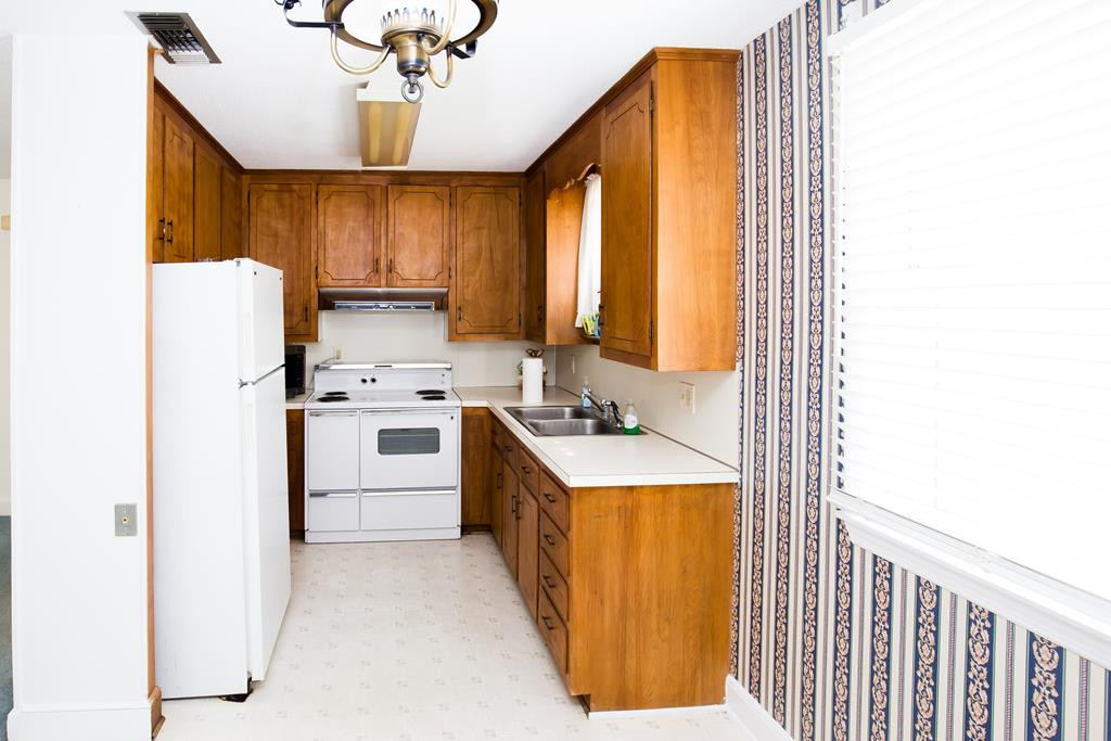 499 Pine Street Bamberg, SC 29003 - Photo 19 of 28 a kitchen with white cabinets and white appliances