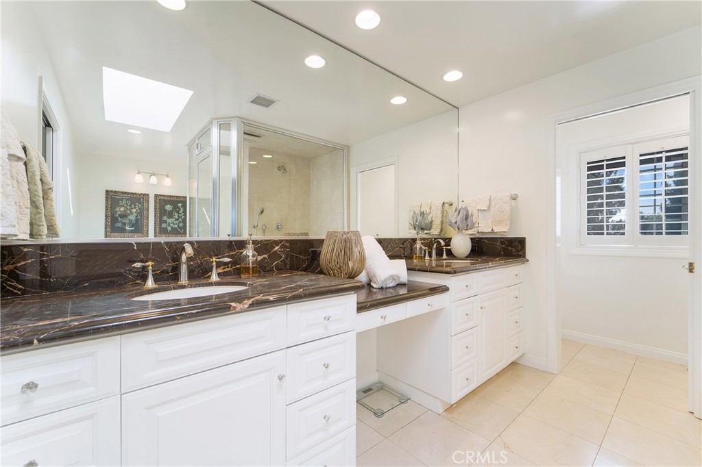 1867 Samar Drive Costa Mesa, CA 92626 - Photo 27 of 38 a bathroom with double sink and a mirror