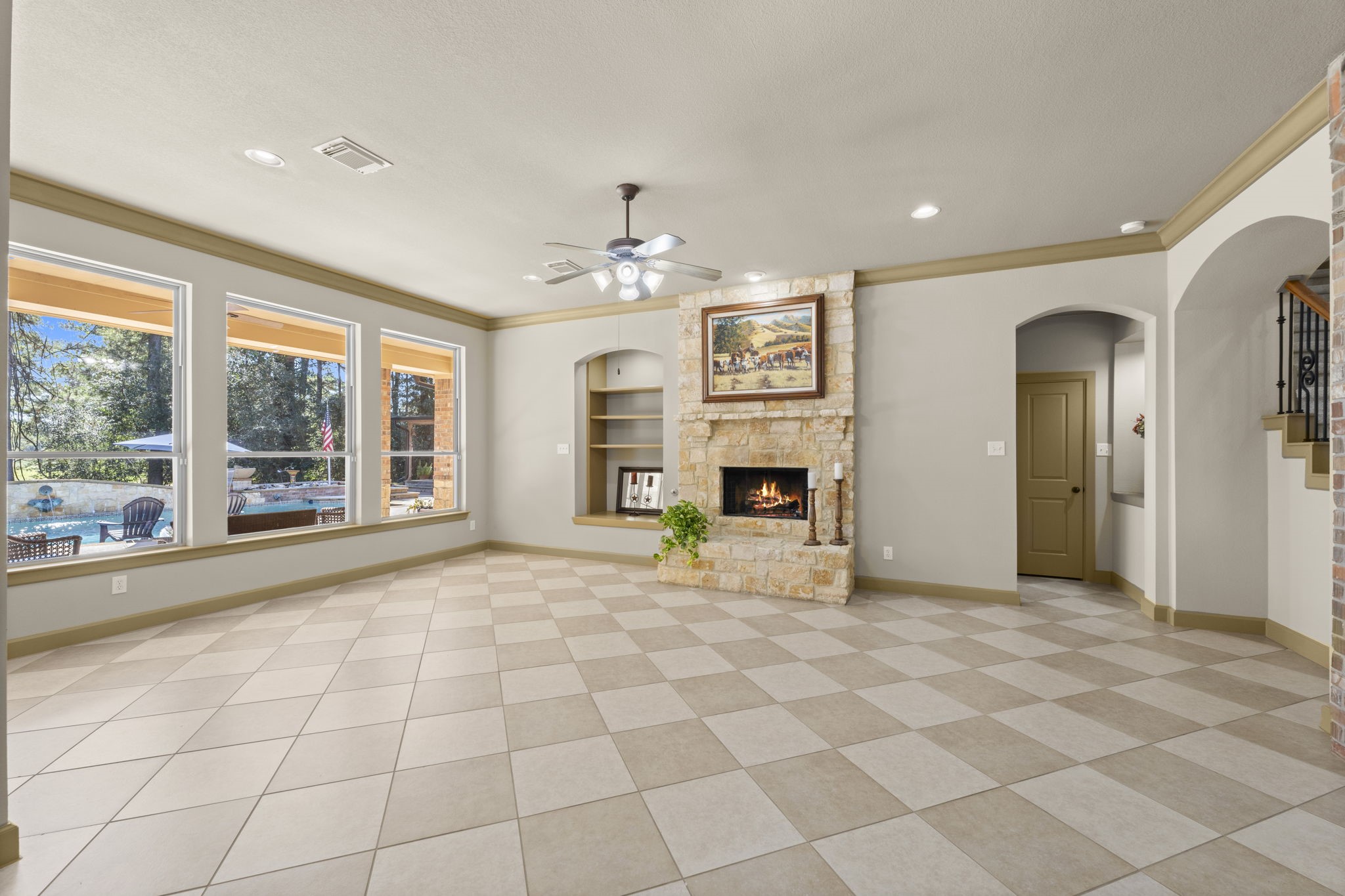 1534 Virgie Community Road Magnolia, TX 77354 - Photo 16 of 50 Plenty of space for your largest furniture in addition to beautiful views of the pool and backyard make this living room an incredible space for daily family use or having some friends over for a party. How would you place your furniture in this room? The gas limestone fireplace is a true focal point of the room.
