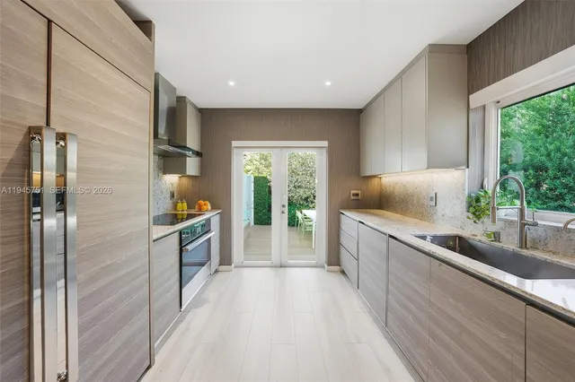a large white kitchen with a large window