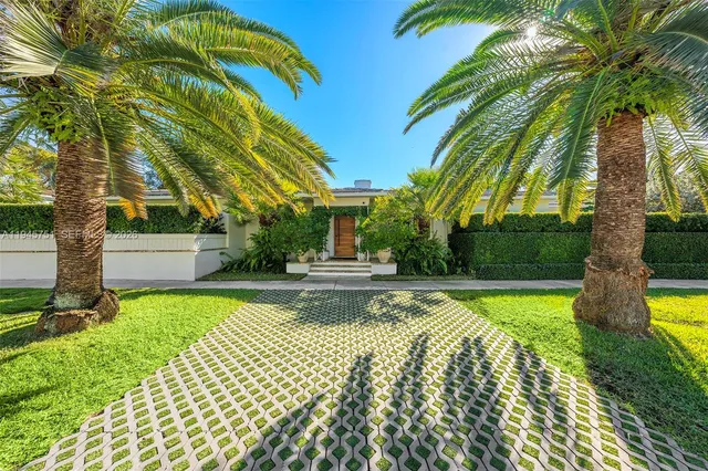a view of a house with swimming pool and sitting area