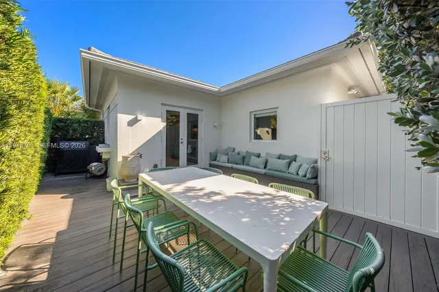 a dinning table and chairs in patio of the house