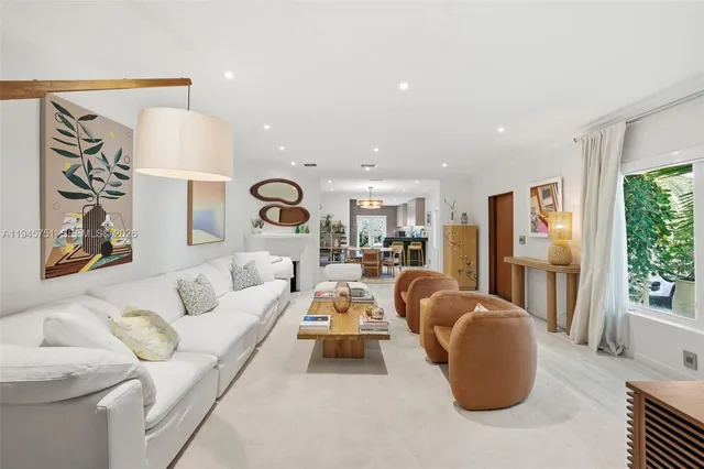 a living room with furniture a lamp and a large window