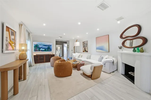 a living room with fireplace furniture and a window