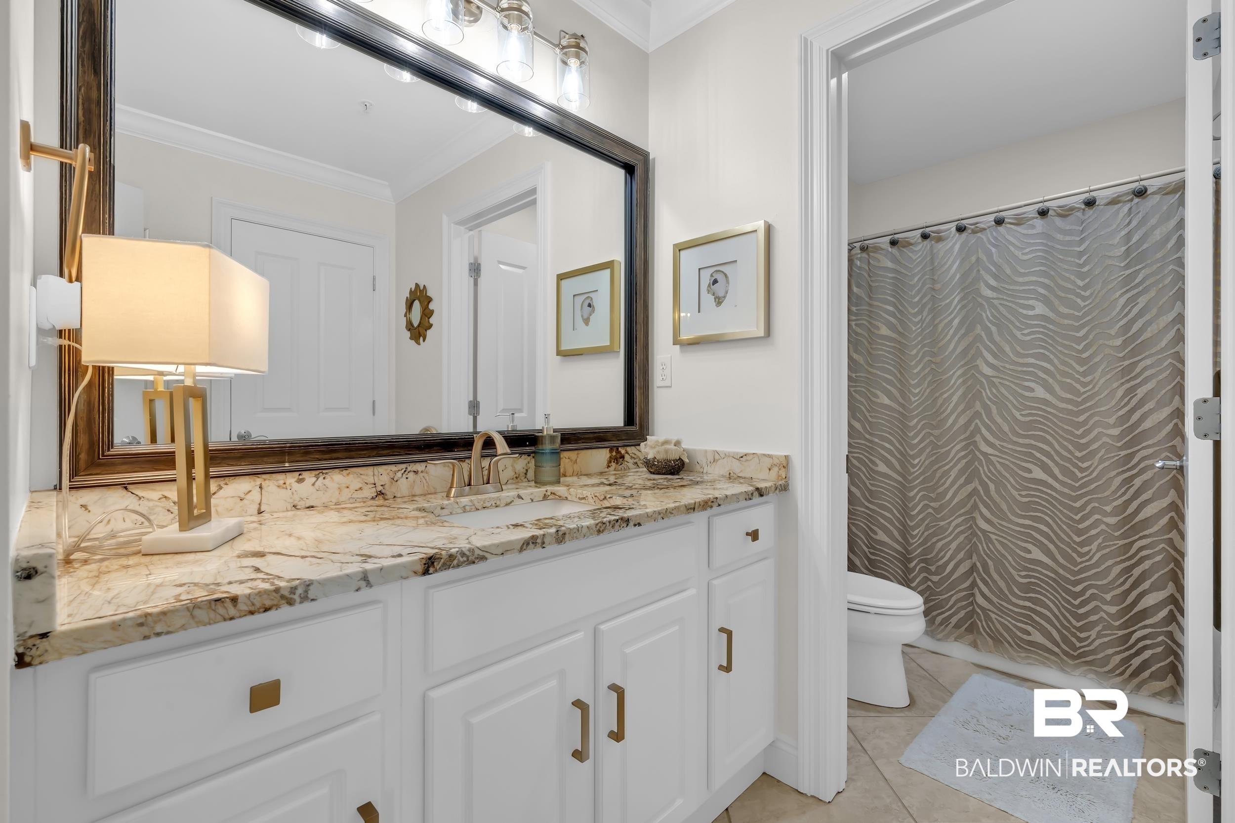 28250 Canal Road, Unit 307 Orange Beach, AL 36561 - Photo 40 of 56 Full bath with crown molding, vanity, a shower with shower curtain, and light tile patterned floors