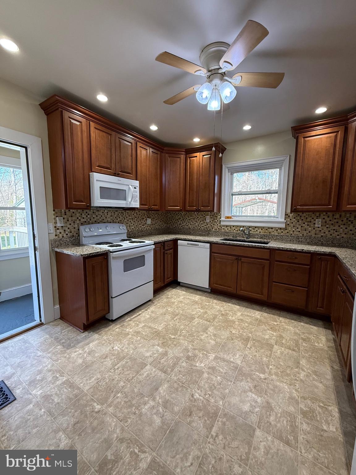 9253 Dahlgren Road King George, VA 22485 - Photo 7 of 23 a large kitchen with stainless steel appliances granite countertop a stove sink and cabinets