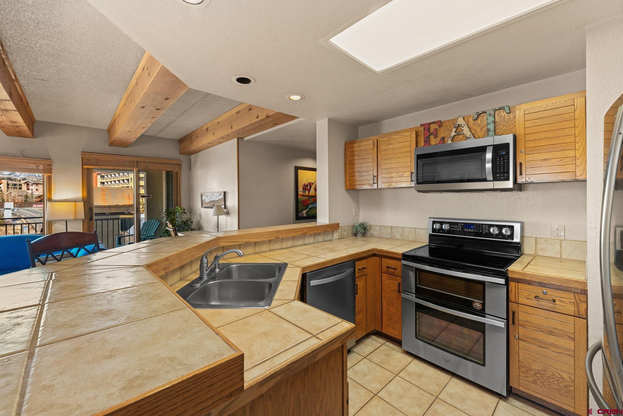 11 Snowmass Road, Unit 638 Crested Butte, CO 81225 - Photo 24 of 41 a kitchen with a sink appliances and cabinets