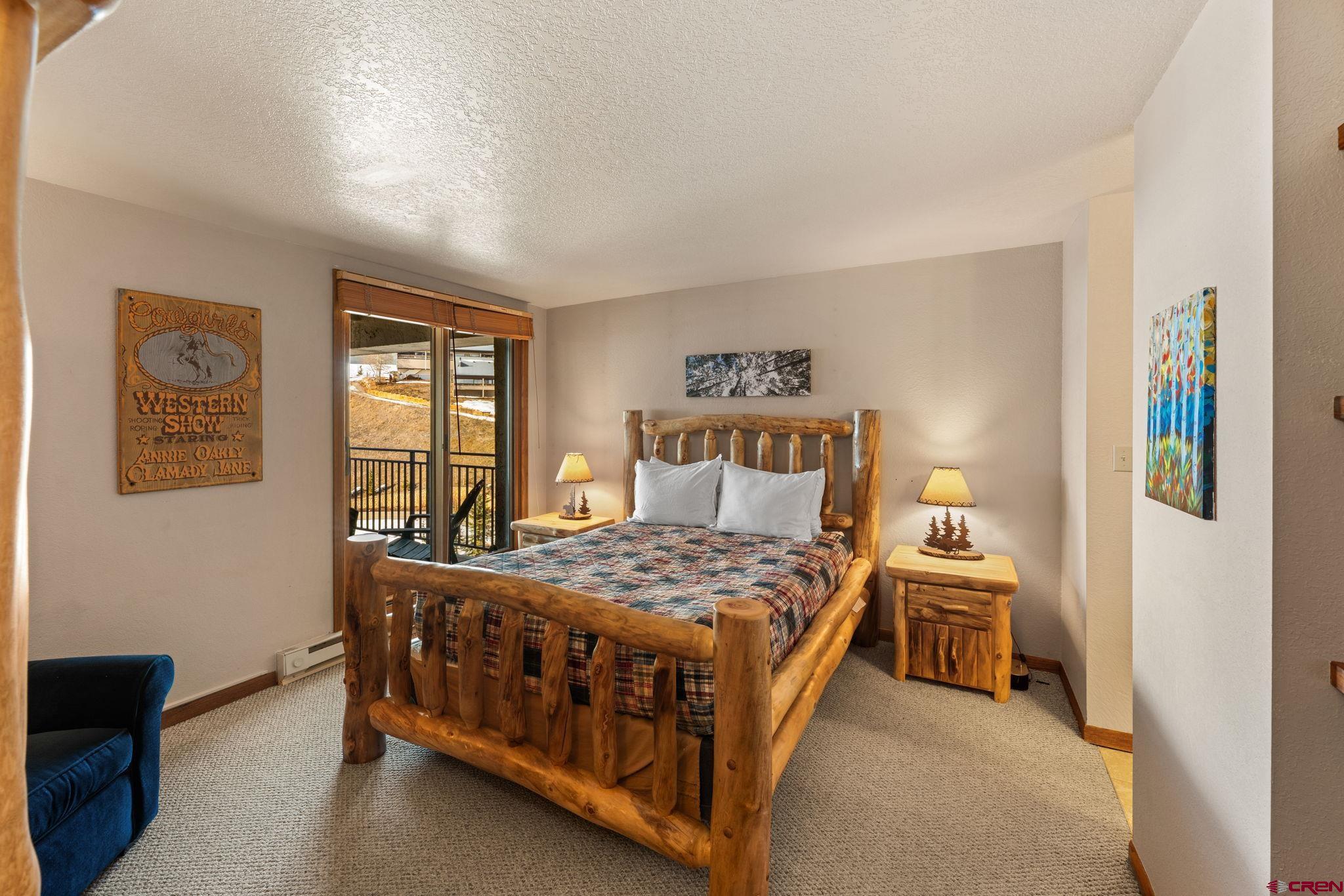 11 Snowmass Road, Unit 638 Crested Butte, CO 81225 - Photo 27 of 41 a bedroom with a bed table and a window