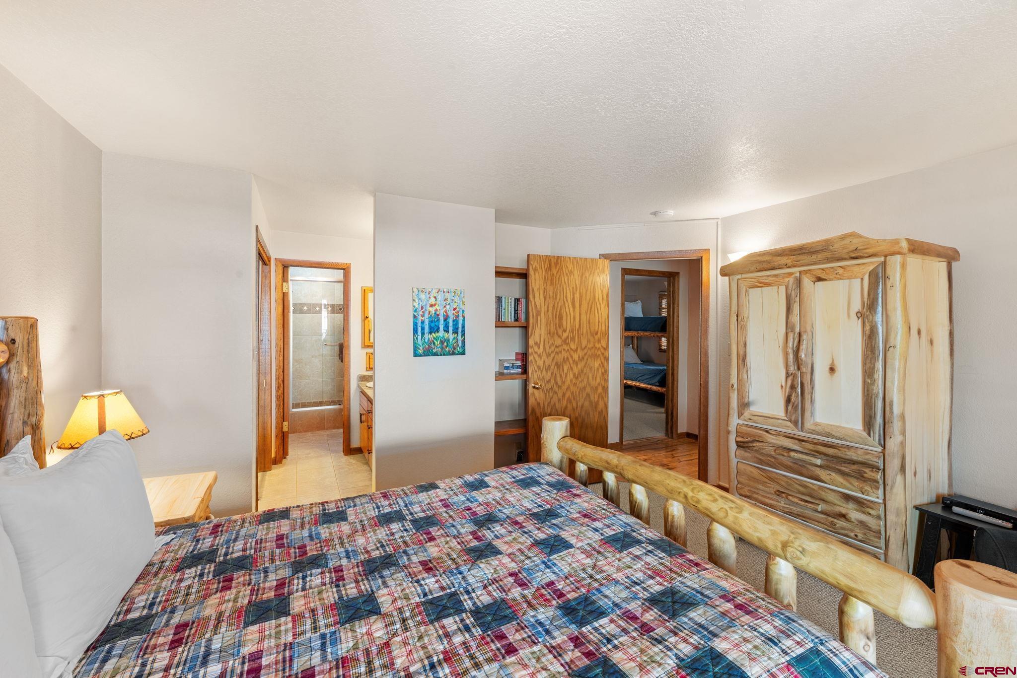 11 Snowmass Road, Unit 638 Crested Butte, CO 81225 - Photo 32 of 41 a bedroom with a bed and wooden floor