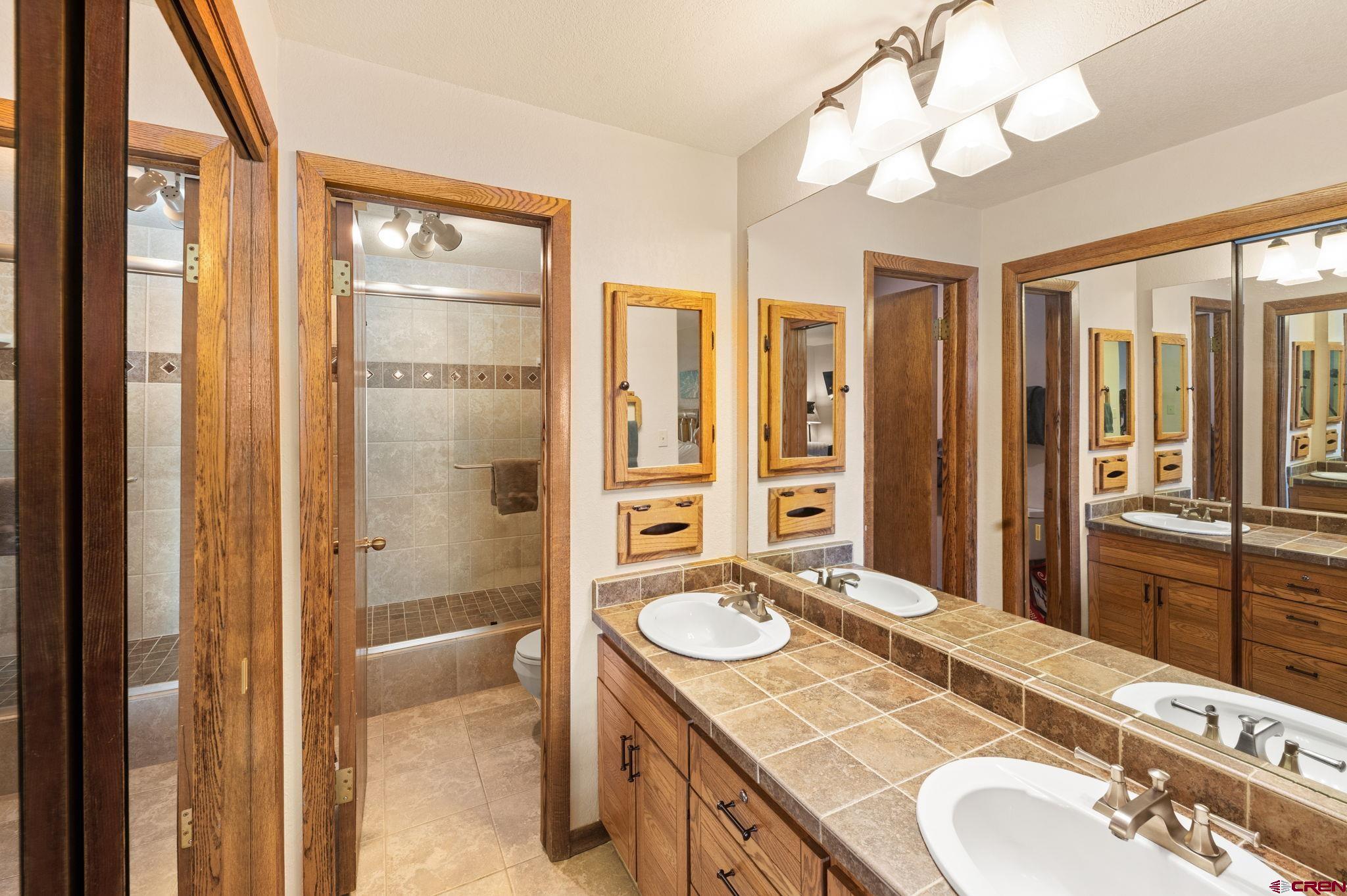 11 Snowmass Road, Unit 638 Crested Butte, CO 81225 - Photo 33 of 41 a bathroom with a granite countertop sink mirror and a shower