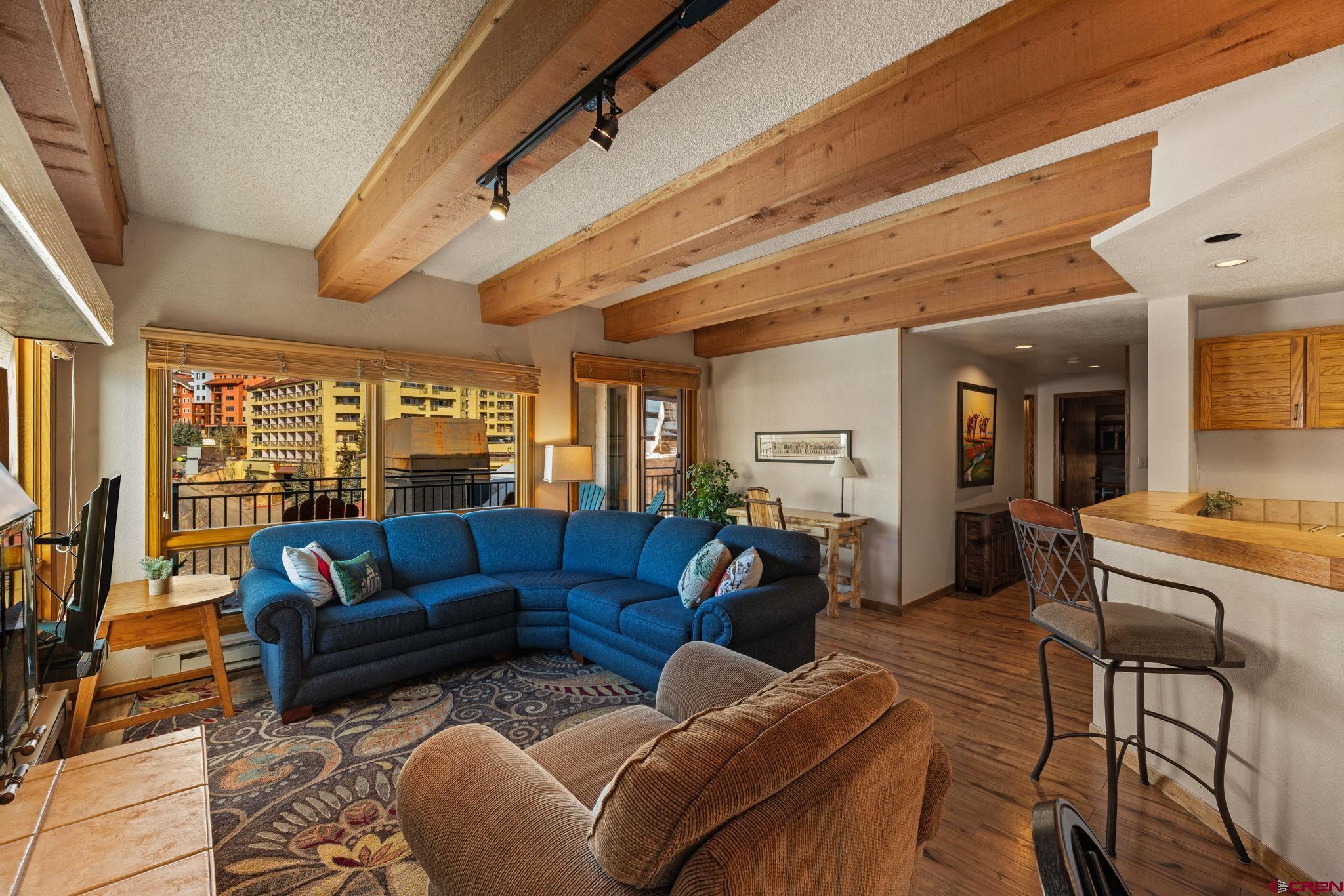 11 Snowmass Road, Unit 638 Crested Butte, CO 81225 - Photo 6 of 41 a living room with furniture and a open kitchen view