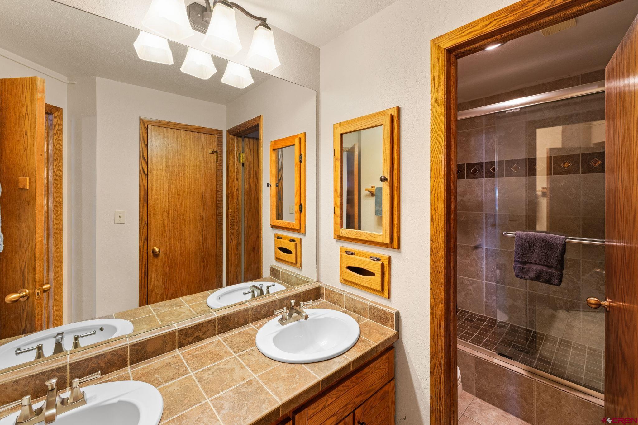 11 Snowmass Road, Unit 638 Crested Butte, CO 81225 - Photo 10 of 41 a bathroom with a granite countertop sink and a mirror