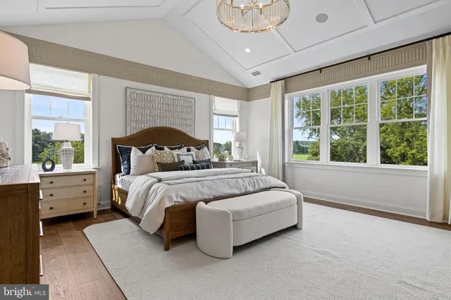 a bedroom with a large bed and a large window