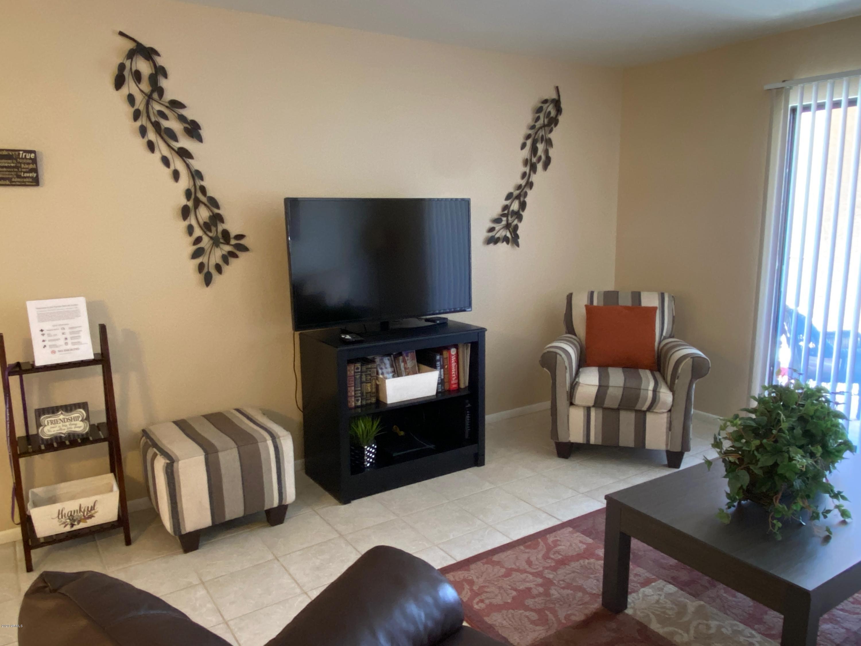 540 South West Road, Unit 7 Wickenburg, AZ 85390 - Photo 2 of 27 a living room with furniture and a flat screen tv