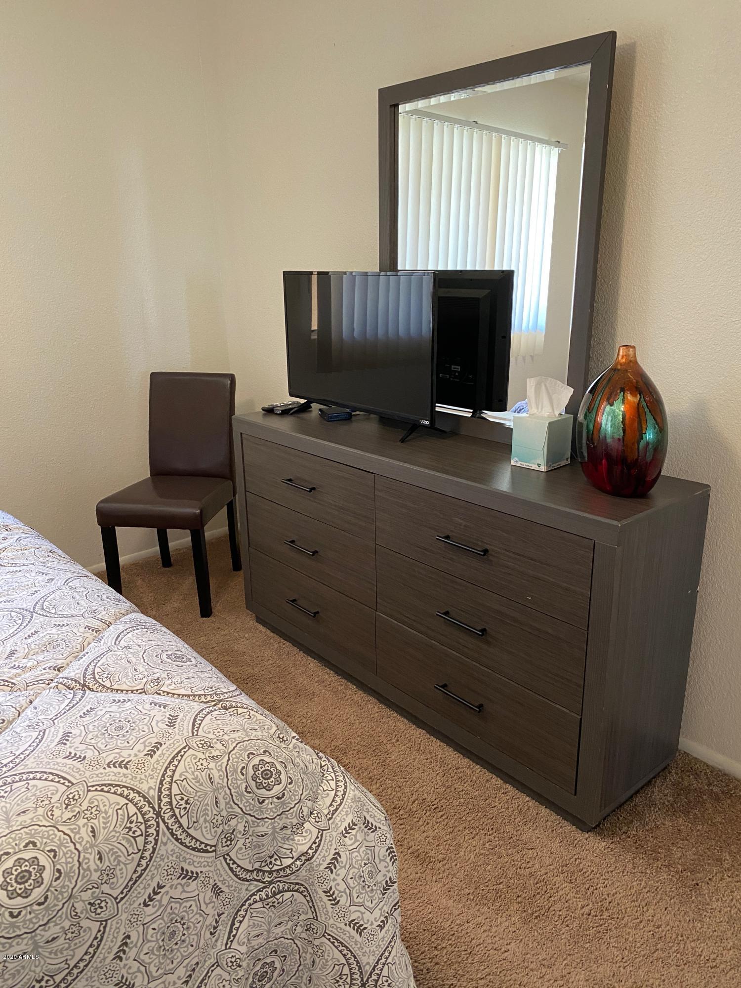 540 South West Road, Unit 7 Wickenburg, AZ 85390 - Photo 7 of 27 a bedroom with a bed and flat screen tv
