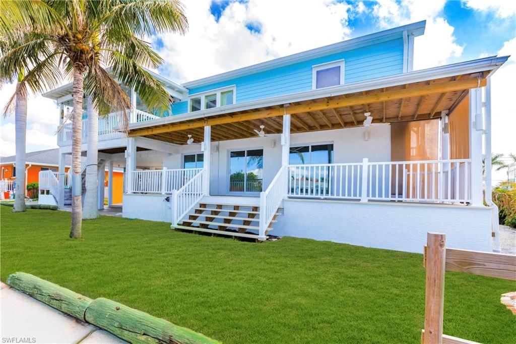 12277 Boat Shell Drive Matlacha Isles, FL 33991 - Photo 4 of 46 a front view of house with a garden