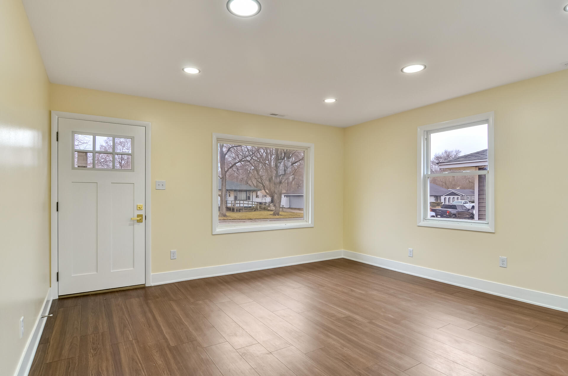 4381 Lincoln Street Gary, IN 46408 - Photo 5 of 24 a view of an empty room with wooden floor and window
