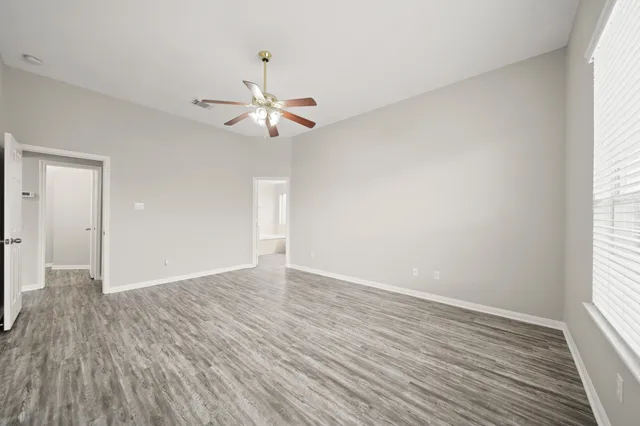 a bathroom with a double vanity sink a mirror and a bathtub