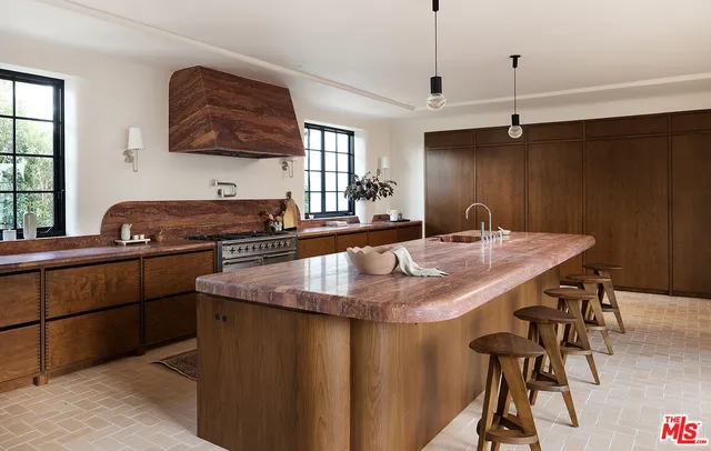 a kitchen with a table chairs and a refrigerator