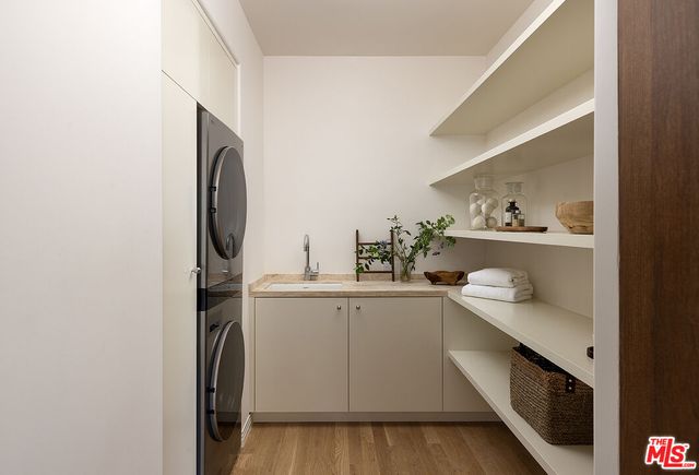 a kitchen with a sink a refrigerator and cabinets