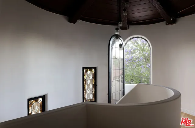 a view of a hallway with paintings on the wall