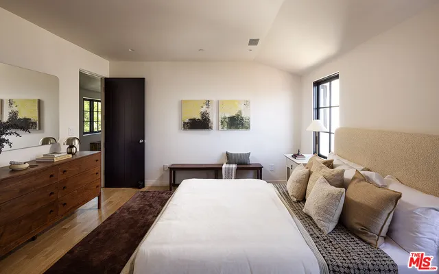 a bedroom with a bed and a chair