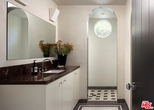 a living room with a couch and a potted plant