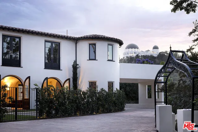 a view of a house with roof deck and sitting area
