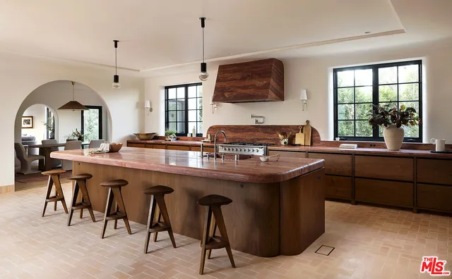 a kitchen with stainless steel appliances granite countertop a sink a stove and a wooden floors