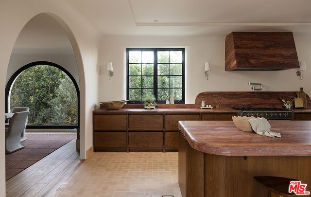 a kitchen with a sink a counter top space and cabinets